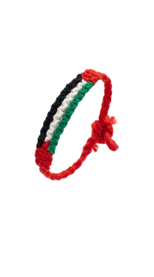 Bracelet with red, black, and green colors on a white background